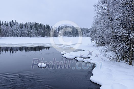 Northern lake scenery in february with snow and ice Northern lake scenery in february with snow and ice