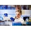 Portrait of a female researcher carrying out research in a chemistry lab (color toned image; shallow DOF)