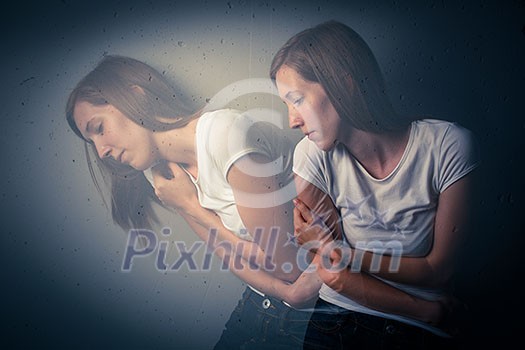 Young woman suffering from a severe depression/anxiety (color toned image; double exposure technique is used to convey the mood of unease, progression of the anxiety/depression) Young woman suffering from a severe depression/anxiety (color toned image; double exposure technique is used to convey the mood of unease, progression of the anxiety/depression)