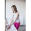 Pretty young woman washing hands in a bathroom