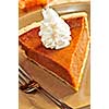 Slice of pumpkin pie with fresh whipped cream