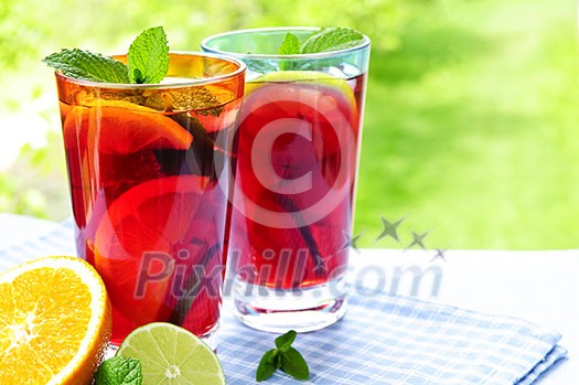 Refreshing fruit punch in two glasses outside Refreshing fruit punch in two glasses outside