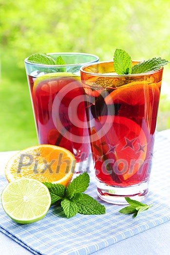 Refreshing fruit punch in two glasses outside Refreshing fruit punch in two glasses outside