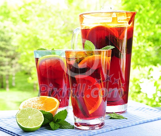 Refreshing fruit punch beverage in pitcher and glasses Refreshing fruit punch beverage in pitcher and glasses