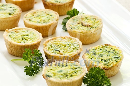 Plate of many mini bite size quiche appetizers Plate of many mini bite size quiche appetizers