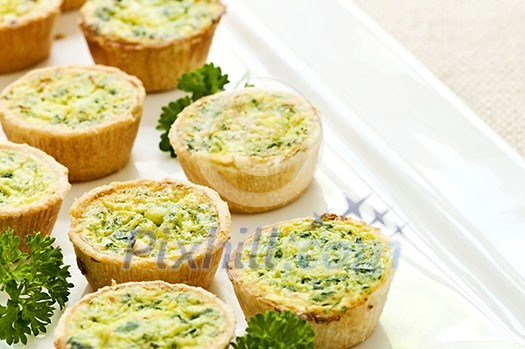 Plate of many mini bite size quiche appetizers Plate of many mini bite size quiche appetizers