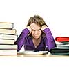 Unhappy teenage girl studying at the desk