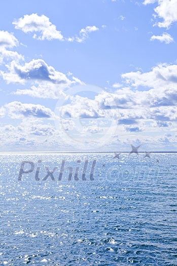 Blue ocean water and sunny sky background