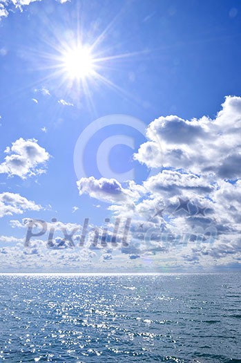 Blue ocean water and sunny sky background