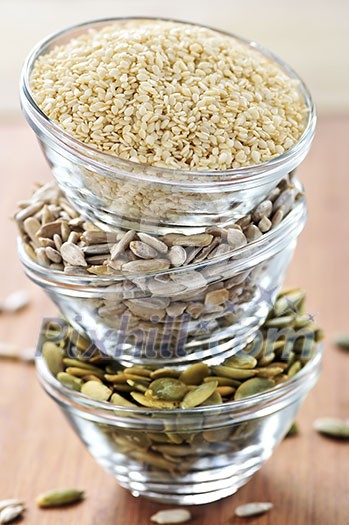 Three stacked bowls of sesame sunflower and pumpkin seeds Three stacked bowls of sesame sunflower and pumpkin seeds