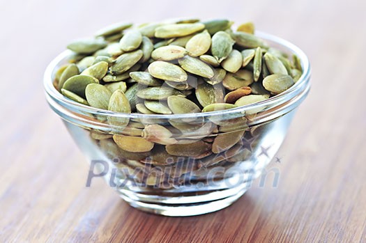 Pumpkin seeds close up in glass bowl Pumpkin seeds close up in glass bowl