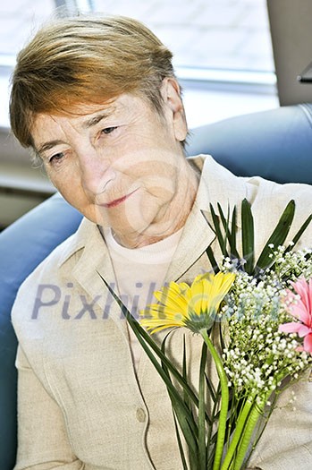 Portrait of sad elderly woman holding flowers Portrait of sad elderly woman holding flowers