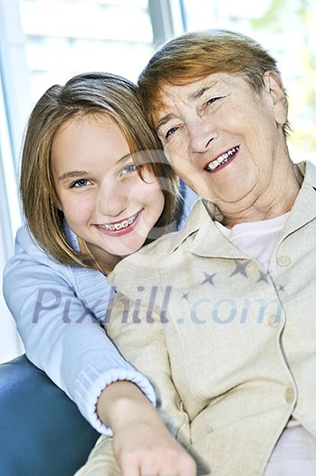 Granddaughter giving a hug to her grandmother Granddaughter giving a hug to her grandmother
