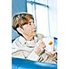 Sad elderly woman sitting with cup of tea