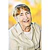 Senior woman laughing and smiling with abstract background