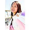 Young korean woman with shopping bags at outdoor mall