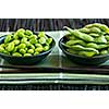 Edamame soy beans shelled and with pods in bowls