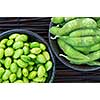 Edamame soy beans shelled and with pods in bowls