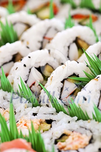 Close up on tray of assorted sushi appetizers Close up on tray of assorted sushi appetizers