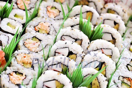 Close up on tray of assorted sushi appetizers Close up on tray of assorted sushi appetizers