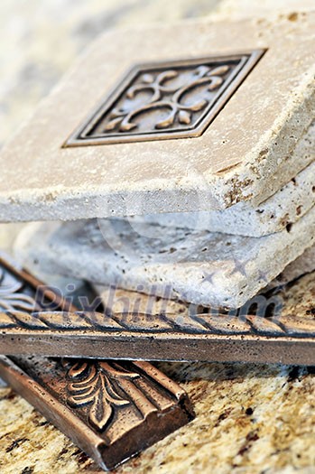 Ceramic tiles and borders for backsplash close up on a granite surface Ceramic tiles and borders for backsplash close up on a granite surface
