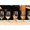 Row of white wine glasses in winery tasting event