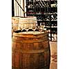 Row of wine glasses on barrel in winery cellar