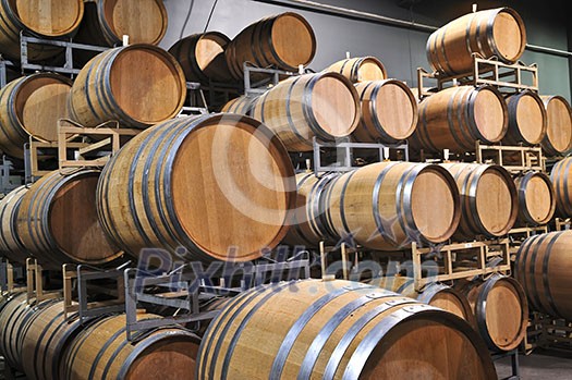 Stacked oak wine barrels in winery cellar Stacked oak wine barrels in winery cellar