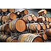 Stacked oak wine barrels in winery cellar