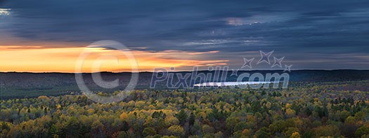 Fall forest trees and sunset viewed from Lookout trail in Algonquin Provincial Park, Canada. Fall forest trees and sunset viewed from Lookout trail in Algonquin Provincial Park, Canada.