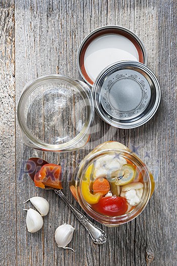 Home preserving mixed vegetables by pickling in glass canning jars Home preserving mixed vegetables by pickling in glass canning jars