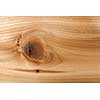 Closeup of red cedar plank showing knot texture and natural woodgrain pattern as wood background