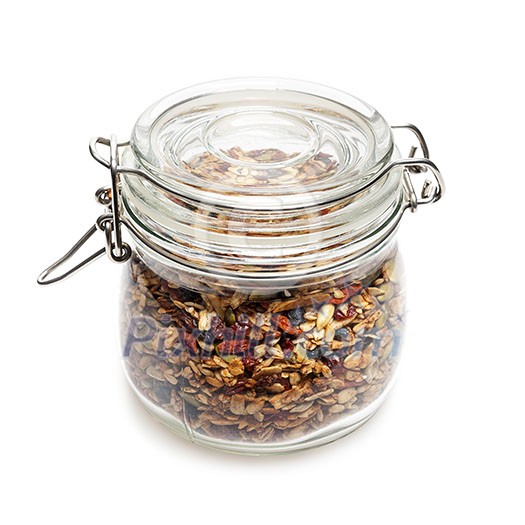 Homemade granola stored in glass jar isolated on white background Homemade granola stored in glass jar isolated on white background
