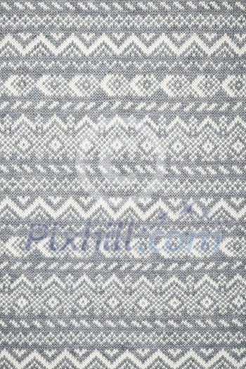 Knit fabric background with knitted grey and white geometric pattern Knit fabric background with knitted grey and white geometric pattern