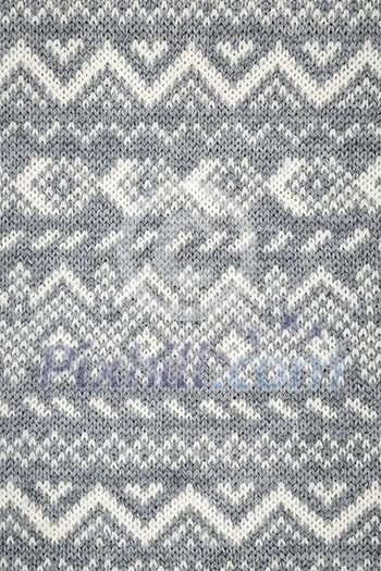 Knit fabric background with knitted grey and white geometric pattern Knit fabric background with knitted grey and white geometric pattern