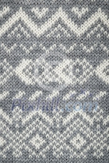 Closeup of knit fabric background with knitted grey and white geometric pattern Closeup of knit fabric background with knitted grey and white geometric pattern