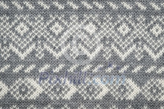 Closeup of knit fabric background with knitted grey and white geometric pattern Closeup of knit fabric background with knitted grey and white geometric pattern