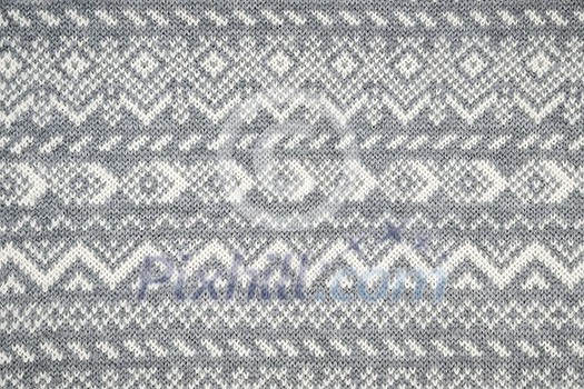Knit fabric background with knitted grey and white geometric pattern Knit fabric background with knitted grey and white geometric pattern