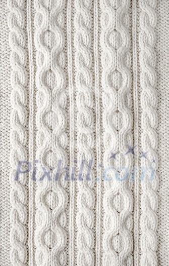 Knit texture of white wool knitted fabric with cable pattern as background Knit texture of white wool knitted fabric with cable pattern as background