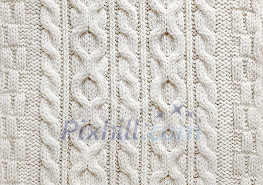 Knit texture of light natural wool knitted fabric with cable pattern as background Knit texture of light natural wool knitted fabric with cable pattern as background