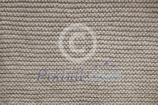 Knit texture of undyed natural brown wool knitted fabric with garter stitch pattern as background Knit texture of undyed natural brown wool knitted fabric with garter stitch pattern as background