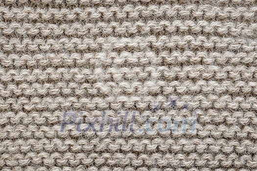 Knit texture of undyed natural brown alpaca wool knitted fabric with garter stitch pattern as background Knit texture of undyed natural brown alpaca wool knitted fabric with garter stitch pattern as background