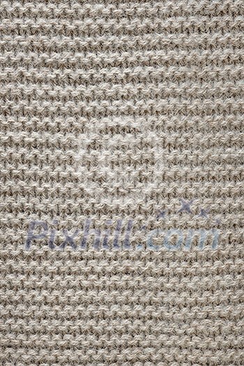 Knit texture of undyed natural brown wool knitted fabric with garter stitch pattern as background Knit texture of undyed natural brown wool knitted fabric with garter stitch pattern as background