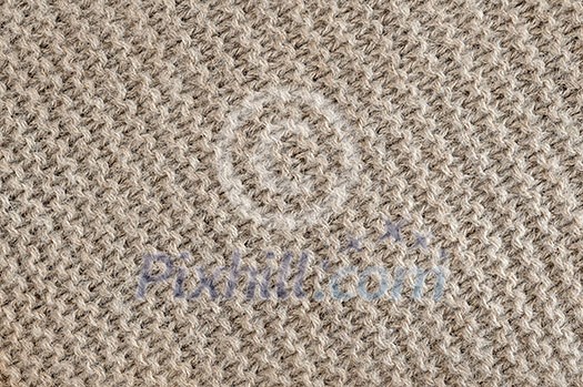 Knit texture of undyed brown alpaca wool knitted fabric with diagonal garter stitch pattern as background Knit texture of undyed brown alpaca wool knitted fabric with diagonal garter stitch pattern as background