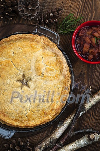 Traditional pork meat pie Tourtiere with apple and cranberry chutney from Quebec, Canada, top view Traditional pork meat pie Tourtiere with apple and cranberry chutney from Quebec, Canada, top view