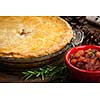 Traditional pork meat pie Tourtiere with apple and cranberry chutney from Quebec, Canada.