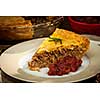 Slice of traditional pork meat pie Tourtiere with apple and cranberry chutney from Quebec, Canada.
