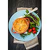 Gourmet meat pie with garden salad served on plate from above