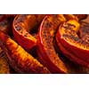 Closeup of freshly roasted pumpkin slices with spices and herbs