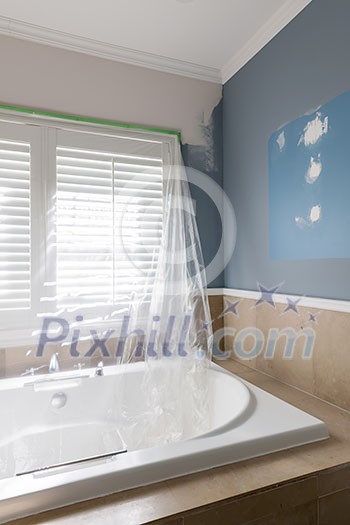 Home renovation of residential bathroom with large tub and stone tile Home renovation of residential bathroom with large tub and stone tile